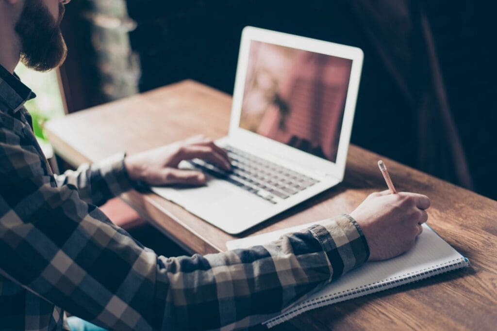 Person typing letter on computer.